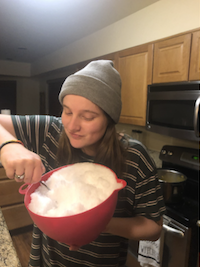 A photo of Anna in the kitchen, holding a bowl of snow and a spoon. One might guess, correctly, that she is about to eat the snow.